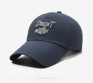 Detail view of navy blue baseball cap with laser-cut perforations and white embroidery