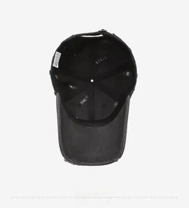 Detailed interior view of 100% cotton distressed baseball cap with washing label