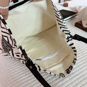 Detail view of the bohemian tote bag interior featuring off-white lining and a zipper pocket