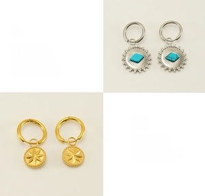 Detailed view of bohemian sunburst earrings featuring turquoise inlay and starburst charms