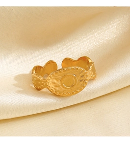 Detail of vintage gold hammer-textured oval ring on elegant beige silk fabric