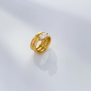 Macro detail of 18K gold-plated multi-layer spiral ring with marquise zircon stone