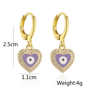 Detailed view of heart-shaped evil eye earrings with gold plating and zircon inlay
