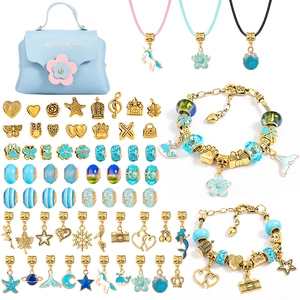 DIY kids jewelry kit featuring light blue bag with golden pendants and beads