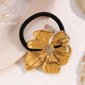 Detailed close-up of 18K gold plated flower hair tie with sparkling white crystals