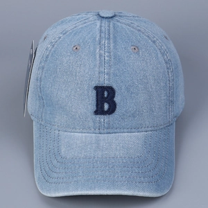 Close-up of the light blue denim baseball cap featuring an embroidered dark blue letter B