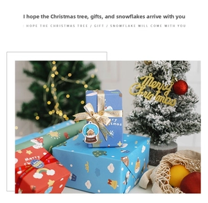 Close-up of Christmas wrapping paper set with colorful patterns, gold ribbons, and tags