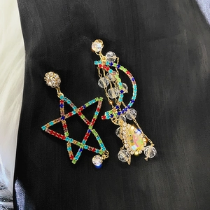 Detail of star and moon earrings with colorful rhinestones and crystal drop tassels