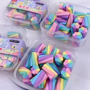 Macro detail of macaron color flower-shaped erasers in transparent plastic box