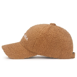 Brown fleece baseball cap with white letter embroidery shown from a side view angle