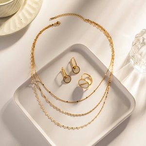 Detailed set of 18k gold triple-layer necklace with shell inlay earrings and ring