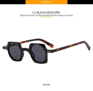 Detail view of punk square sunglasses with black frame, tortoiseshell temples and grey lenses
