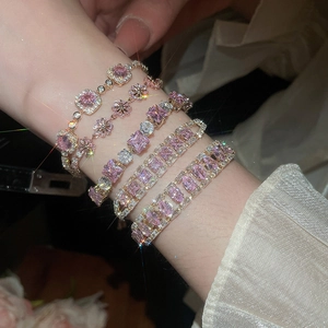 Detail of five rose gold bracelets with pink zircon stones in geometric floral designs