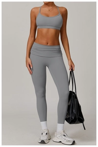 Close-up of grey high-waisted yoga pants with fold-over waistband and matching sports bra