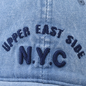 Light blue washed denim baseball cap featuring navy blue NYC embroidery on structured crown