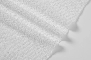 Macro shot of white sheer mesh fabric texture with soft drape and delicate knit detail