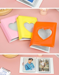 Three-color 3-inch heart cutout photo albums in pink, yellow, and orange with clear pockets