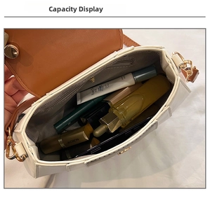 Internal view of small square crossbody bag showing main compartment and zipper pocket
