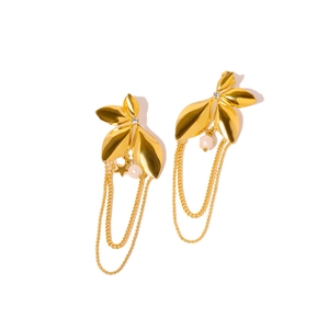Golden leaf earrings with tassels, stars and pearls on a clean white background