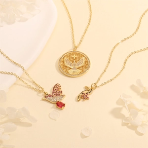 Detailed shot of gold plated necklaces with eagle and bird pendants with colorful zircons