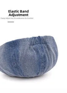 Detail view of the adjustable elastic strap on the blue denim newsboy cap for head size fit