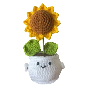 Handmade crochet sunflower potted plant with a cute smiley face on a white base