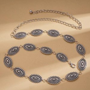 Detail of vintage silver waist chain featuring engraved oval metal plates and lobster clasp