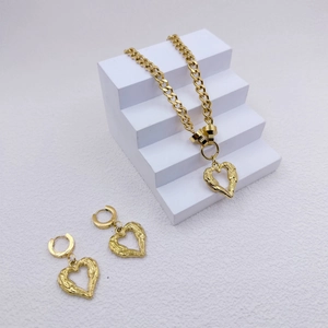 Golden stainless steel jewelry set featuring chunky chain necklace and heart pendants