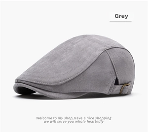 Detail of grey suede ivy cap featuring a vintage metal buckle and precise stitching