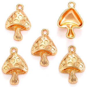 Detailed view of five golden mushroom pendants with polished finish for DIY jewelry making