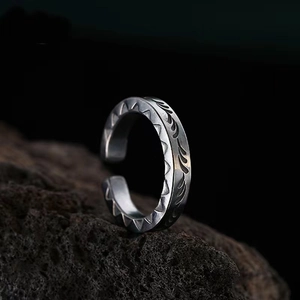 Detailed macro shot of vintage tribal feather engraving on a retro silver spearhead ring