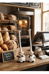 Detail of creative resin chef figurines holding a tray and knife for bakery decor