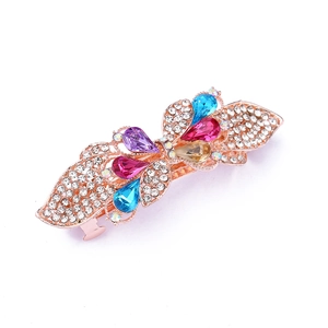 Rose gold bow hair clip with colorful crystal rhinestones on a clean white background