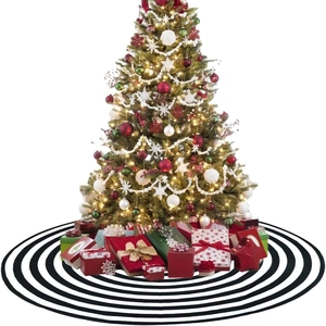 Christmas tree skirt with black and white stripes and gift boxes on festive tree