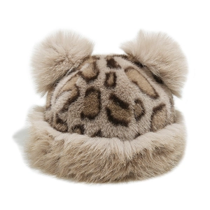 Close-up of leopard print faux fur winter hat with soft bear ear pom-poms on white background