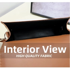 Detail view of the brown leather crossbody bag showing inner compartment and stitching
