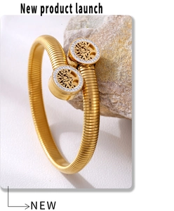 Macro detail of 18k gold plated Tree of Life bracelet with crystals on a natural stone