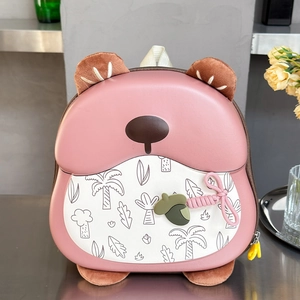 Close-up of pink hard-shell kids backpack with 3D bear ears and acorn charm detail
