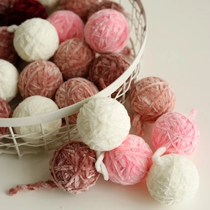 Handmade soft chenille Christmas yarn balls in white and pink tones for holiday DIY decor