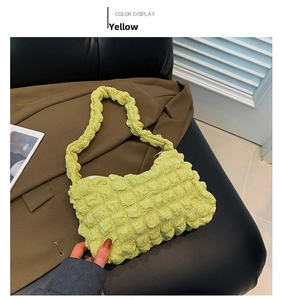 Detail of yellow pleated cloud puffy bag with ruffled strap and elastic bubble fabric