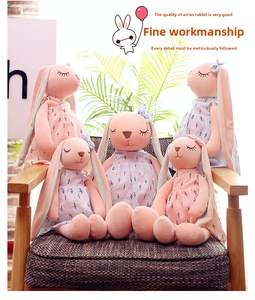 Set of five pink plush floppy ear bunnies wearing floral dresses on a wooden chair