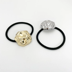 Detail of high-elasticity hair ties with textured gold and silver metallic accents
