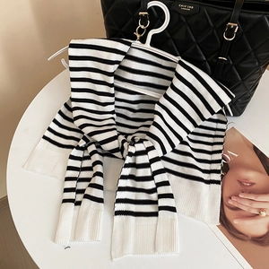 Detailed view of the black and white striped knit shawl with soft ribbed edges texture