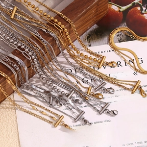Detail of multi-layered 18K gold and silver plated stainless steel chains with lobster clasps
