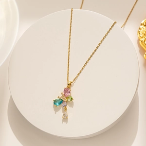 Detailed shot of gold titanium necklace featuring a colorful zircon butterfly pendant on a stand