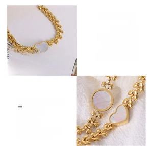 Macro detail of 18K gold plated wheat chain bracelet featuring white shell heart inlays
