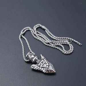 Detailed view of silver Viking Valknut symbol engraved on a triangular arrowhead pendant