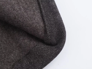 Macro shot of grey wool knit texture and reinforced seam details on winter socks