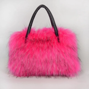 Detail of pink faux fur tote bag showing long plush texture and black leather handles
