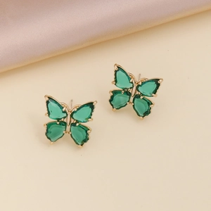 Detail shot of butterfly stud earrings in gold finish with green cubic zirconia stones
